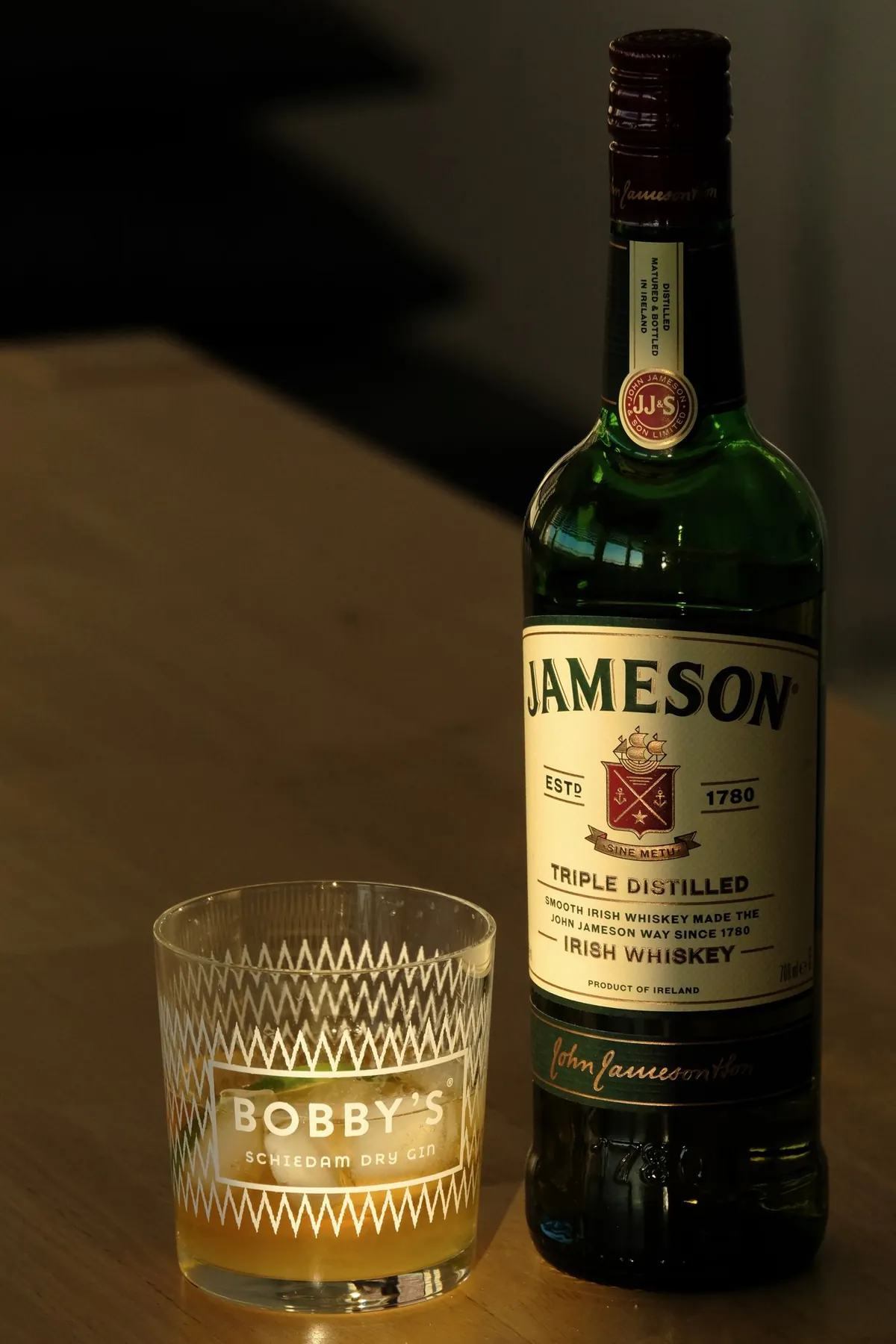 Real whisky bottle and glass photographed in a warm private bar setting